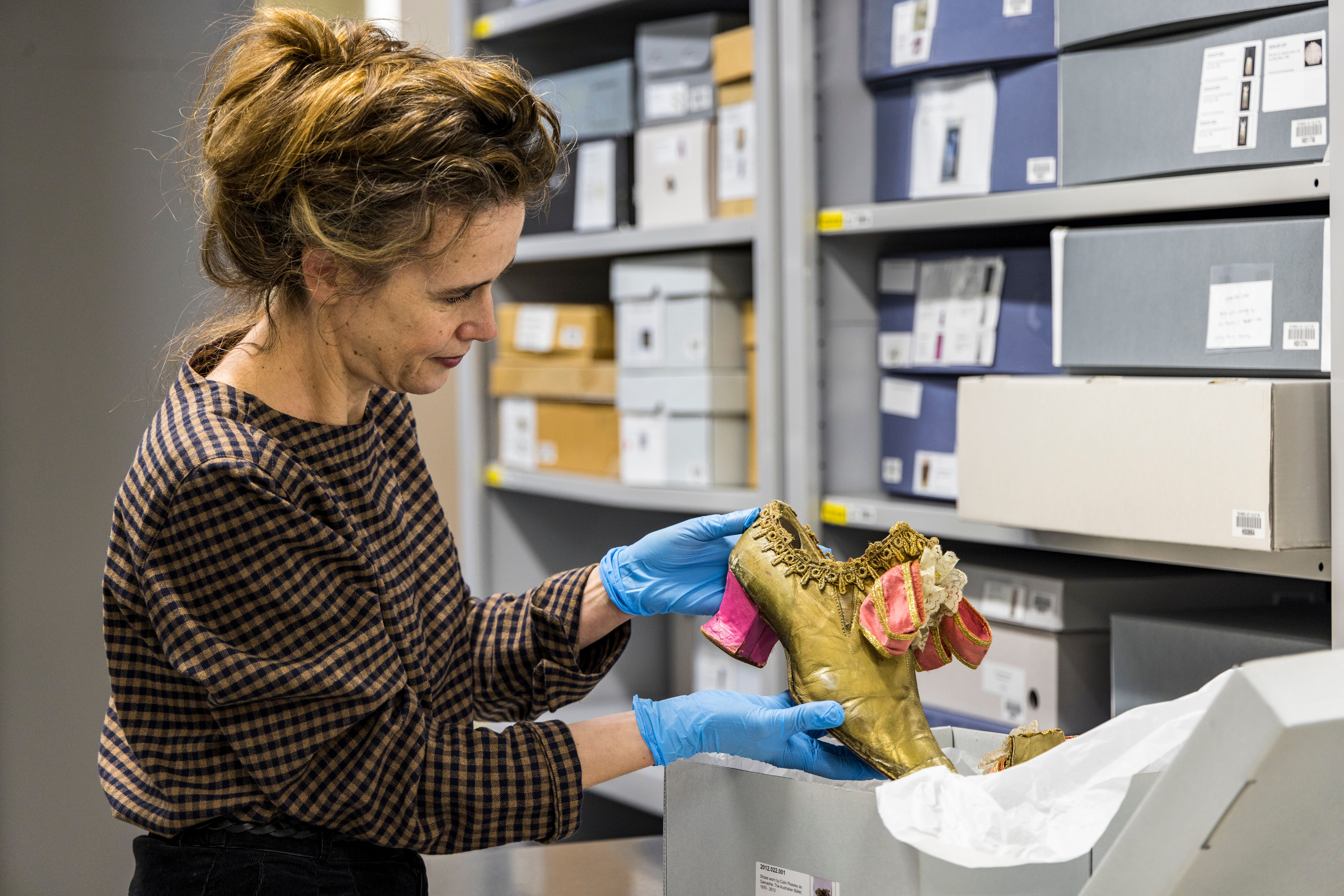 Curator Margot Anderson with shoes from Don Quixote. Photographer Mark_Gambino